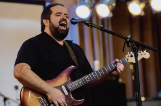 Man playing guitar and singing